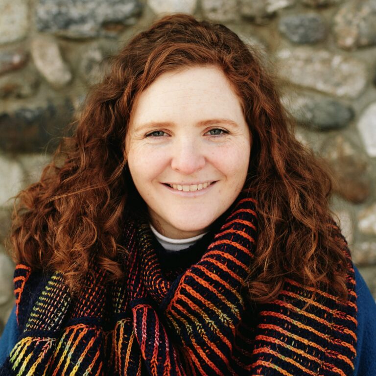 victoria headshot, in front of stone wall