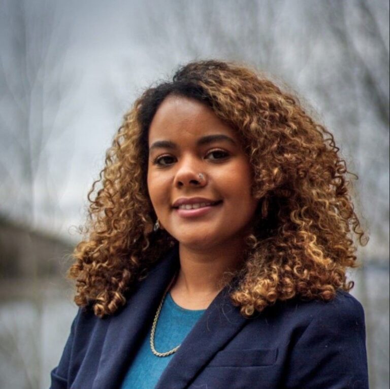 Cora headshot with scenic background