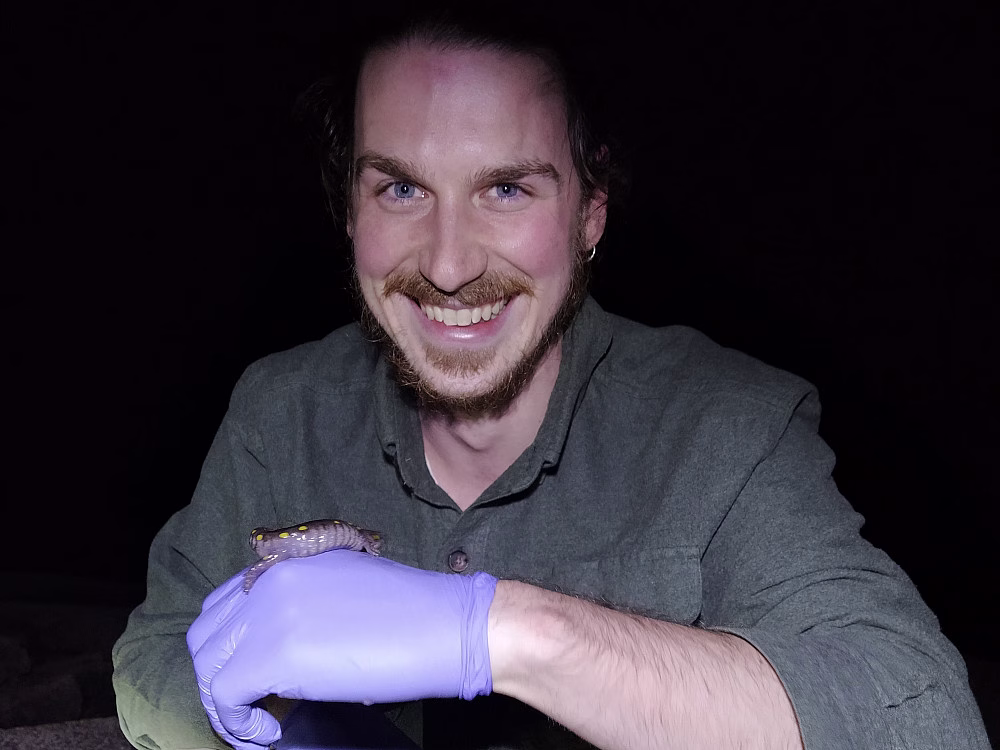 Person holding a small animal.
