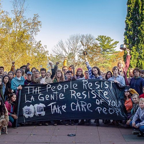 Protesters holding a large banner.