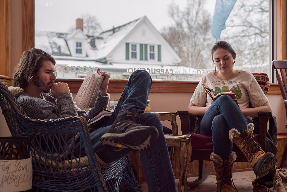 Two people reading in a café.