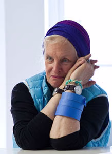 Person with colorful headscarf and bracelets.