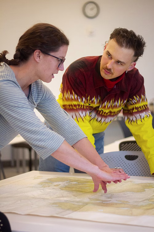 COA computer science professor Laurie Bake goes over charts of Frenchman Bay with Camden Hunt 