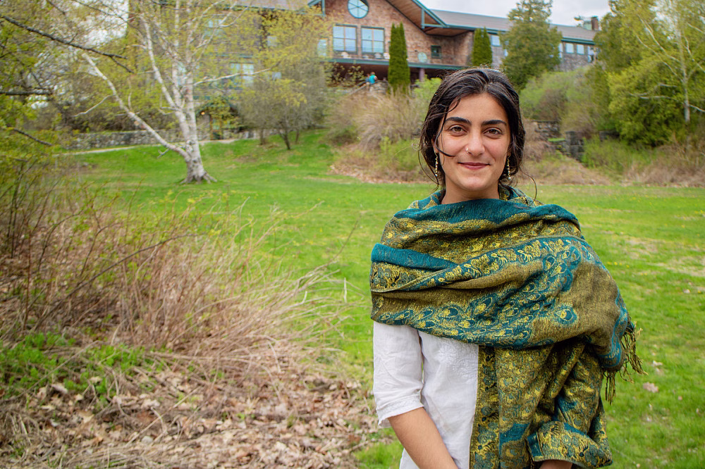 Person wearing a colorful shawl outdoors.