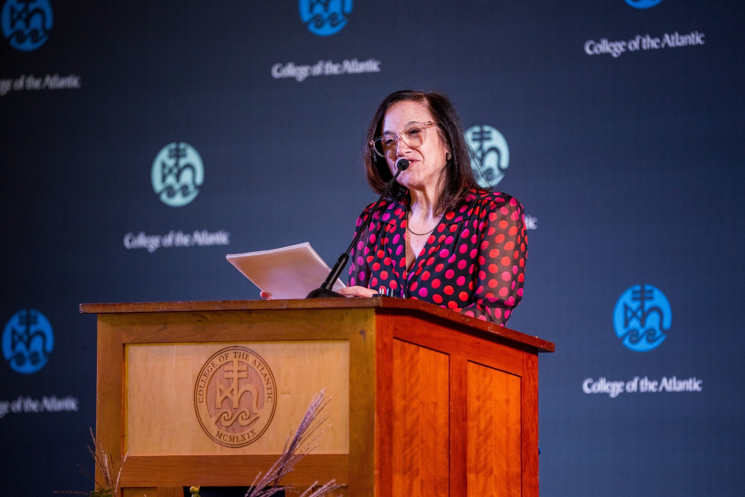 Sylvia talking at a podium