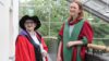 two people in graduation regalia