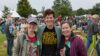 Three women at outdoor festival.