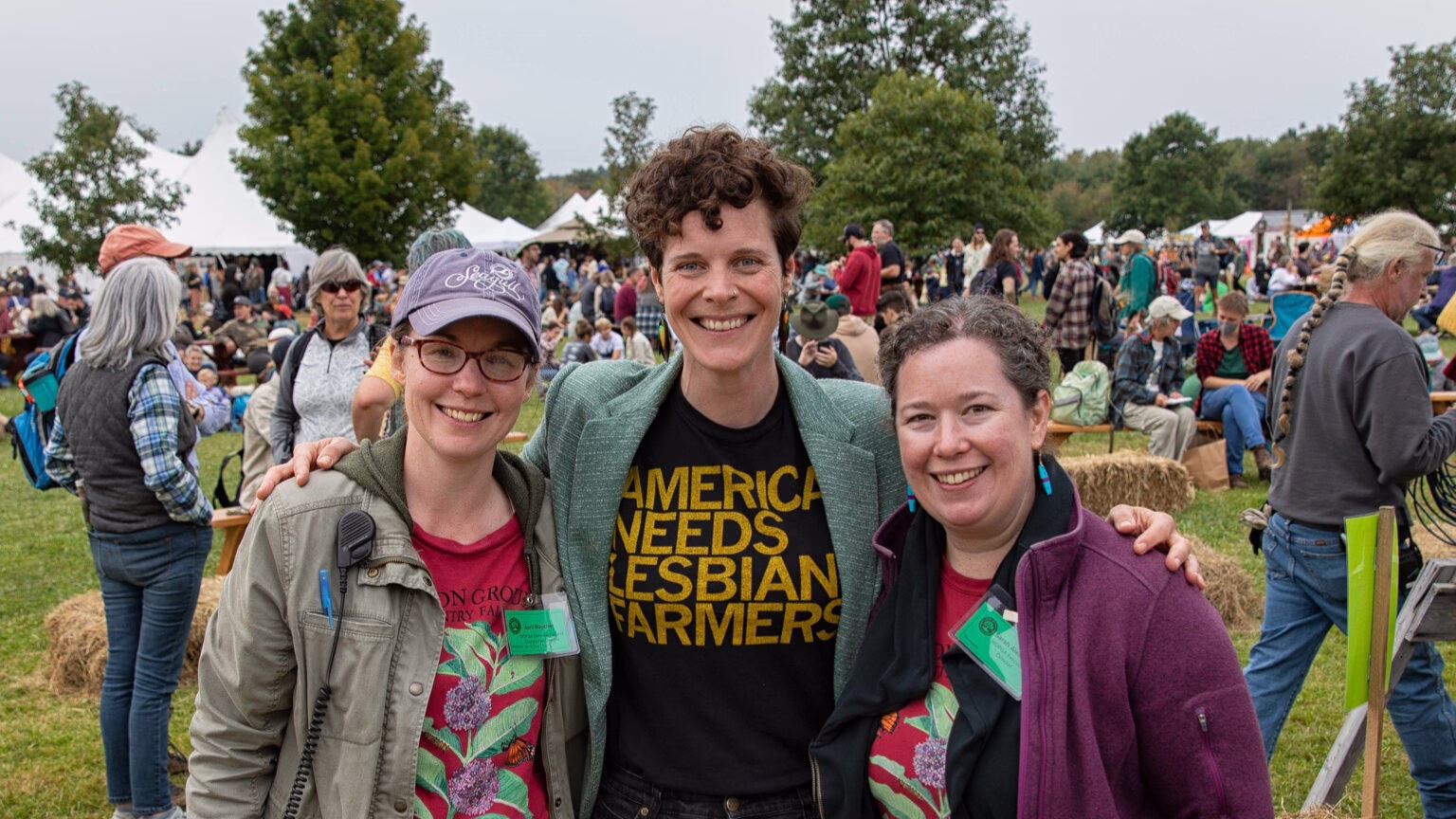 Three women at outdoor festival.