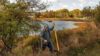 Man walking by a serene lake