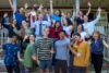 Group of people celebrating together outdoors.